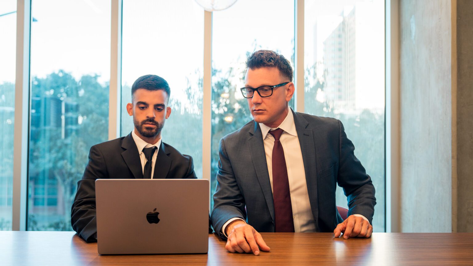 Mesa personal injury attorney AJ Hall and the AJ Hall Injury Law Team reviewing a client file in the Phoenix office