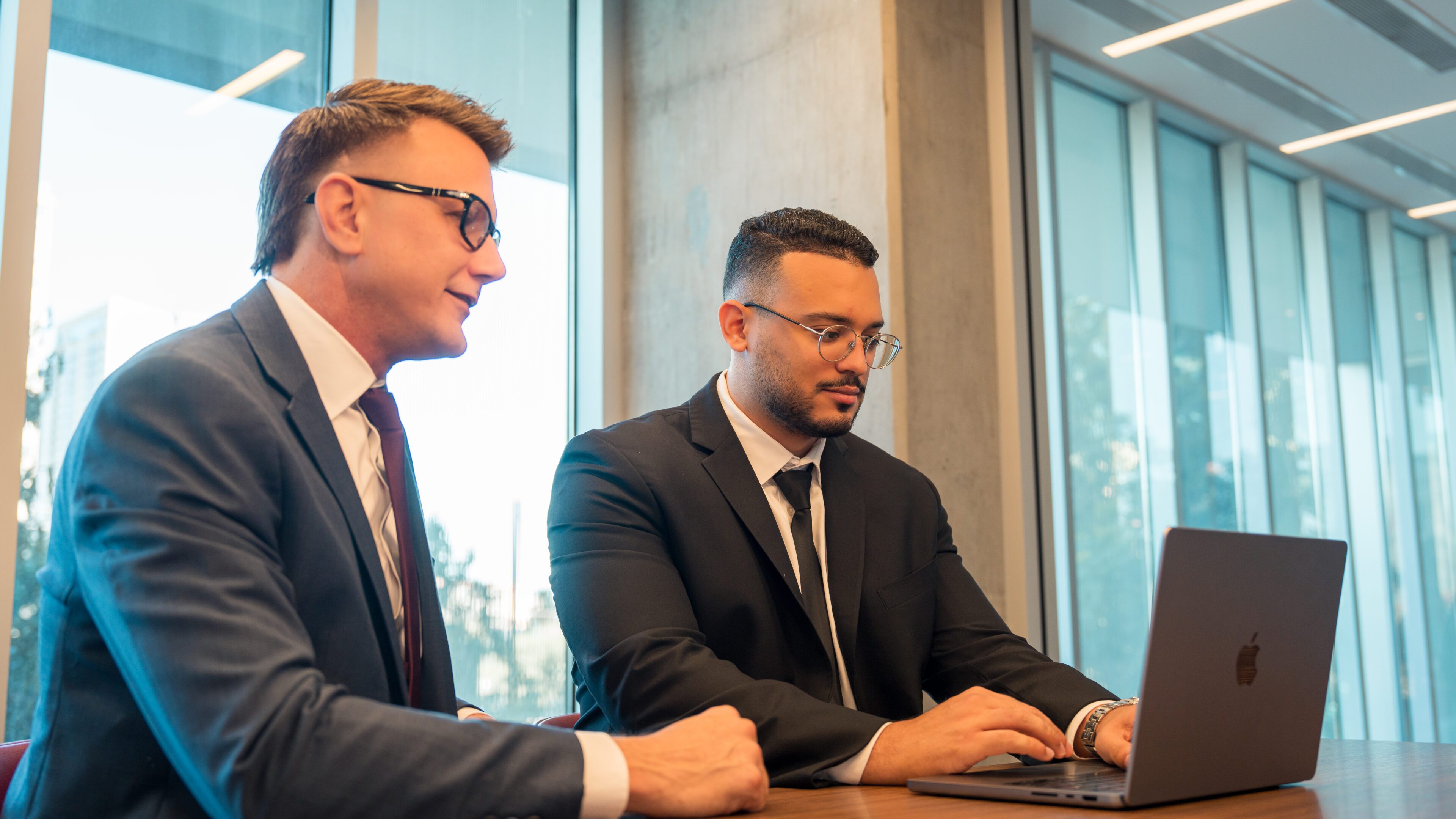 Attorney AJ Hall and Dr. Rolando Contreras reviewing case records together at AJ Hall Injury Law Team in Phoenix
