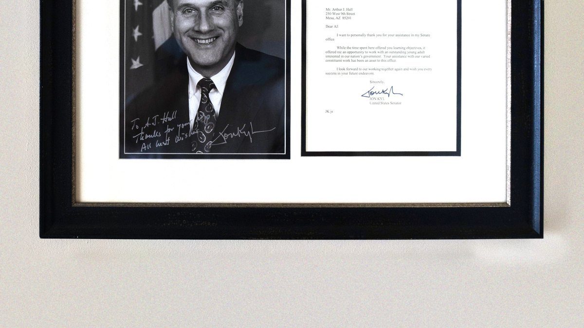Senator Jon Kyl signed photo and 2002 letter framed in AJ Hall's home office